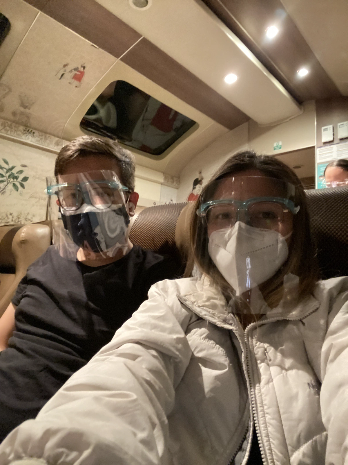 We made it! It's already dark and most of the people on the train are also pooped! Time for our faceshields and mask combo.